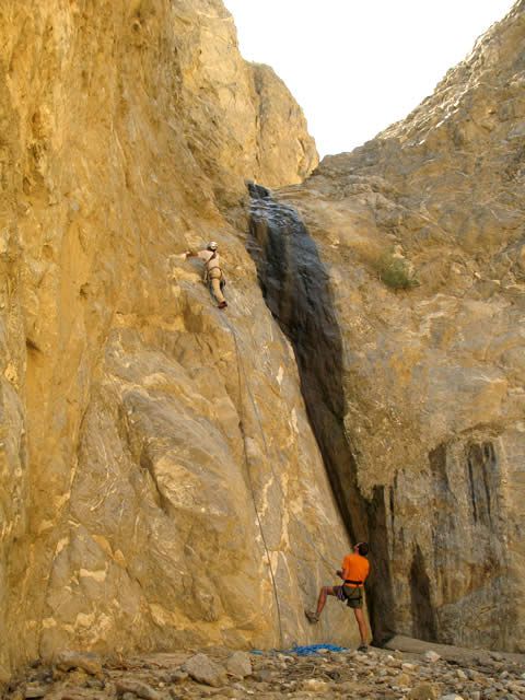 Placing anchors up on the rock cliff at the first waterfall